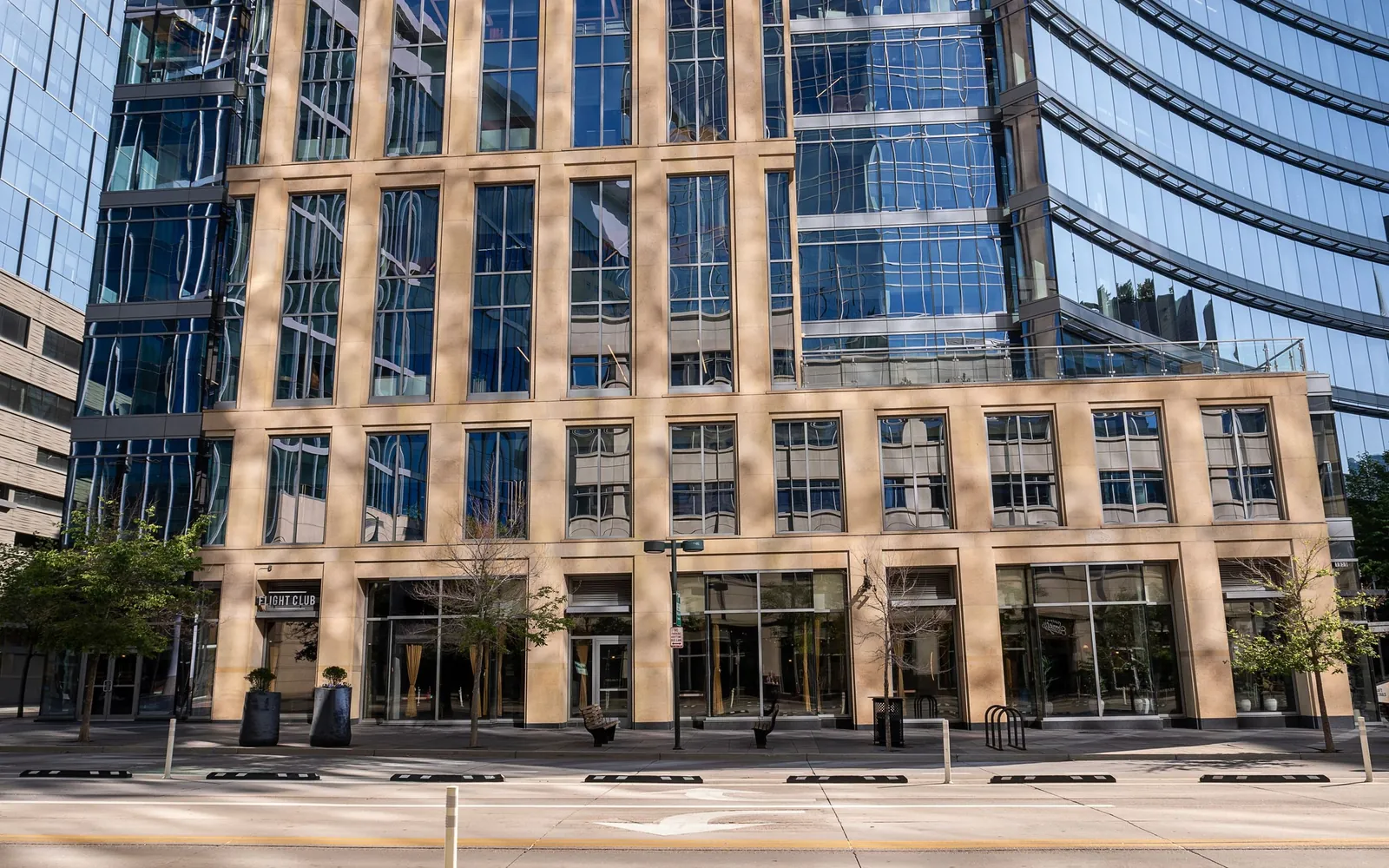 Modern commercial office building with a reflective glass facade.